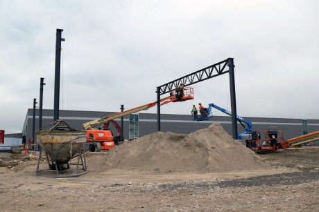 7-6-22: Ironworkers erecting the steel columns, girders, and joists to support the expansion walls and roof