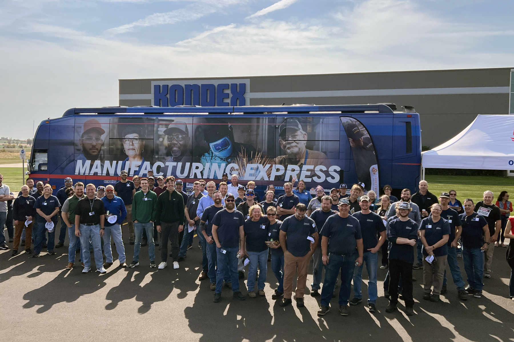 Kondex associates gather in front of AEM's Manufacturing Express bus